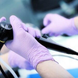 a doctor's hands holding an endoscopy instrument